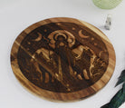 Wooden cutting board with engraved design of Hecate with a wolf on a white surface