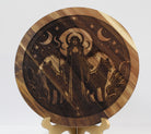 Wooden disc with engraved design of Hecate and animals on a stand